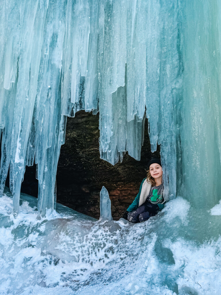 Child exploring inside Midland Ice Caves New Brunswick winter hike